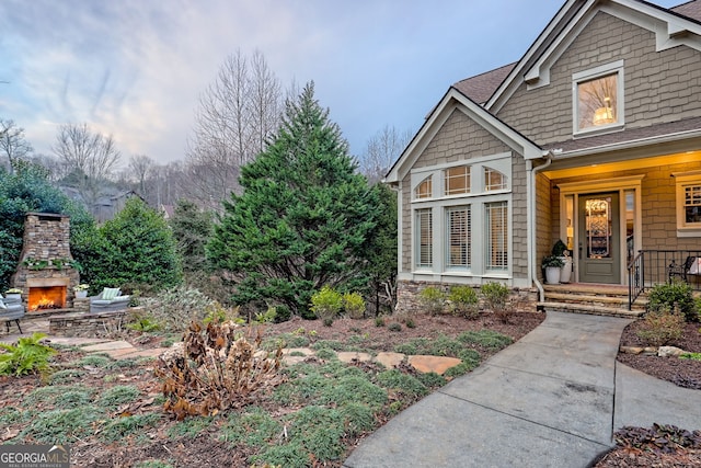 view of yard with a patio and an outdoor stone fireplace