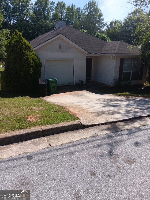 ranch-style home with a front yard and a garage