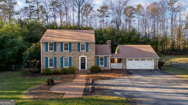 view of front of house with a garage and a front lawn