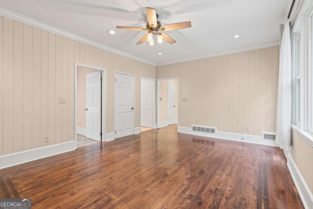 unfurnished bedroom featuring ceiling fan, dark wood-type flooring, and ornamental molding