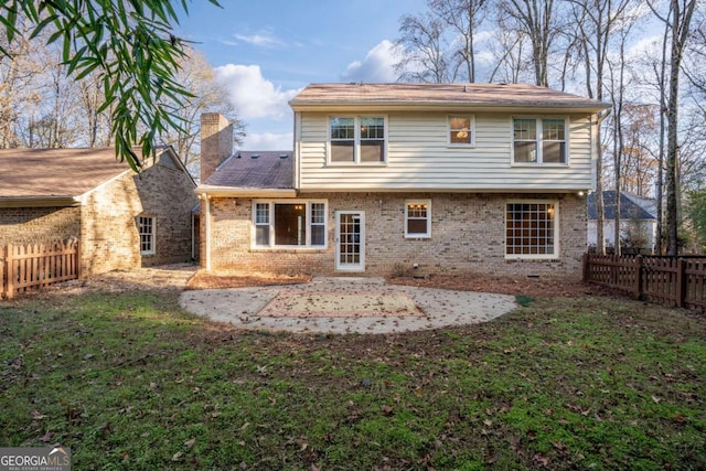 rear view of property featuring a patio and a yard