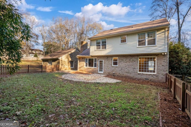 back of property featuring a patio and a lawn