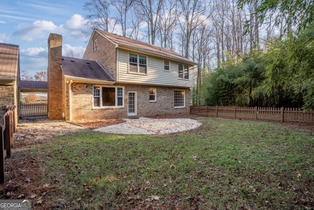 back of house featuring a yard and a patio area