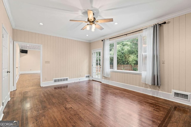 spare room with hardwood / wood-style floors, ceiling fan, and crown molding