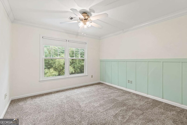 carpeted empty room featuring ceiling fan and crown molding