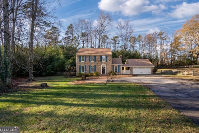 view of front of house with a garage and a front yard