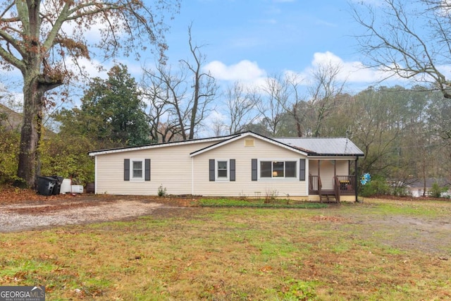 view of front of home with covered porch and a front yard