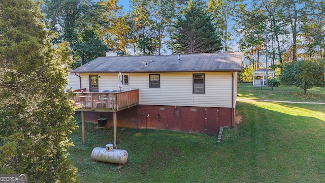 back of house featuring a yard and a deck