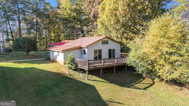 back of house with a yard and a wooden deck