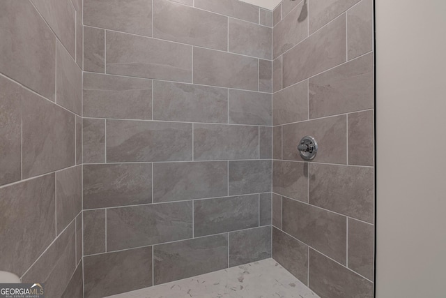 bathroom with tiled shower