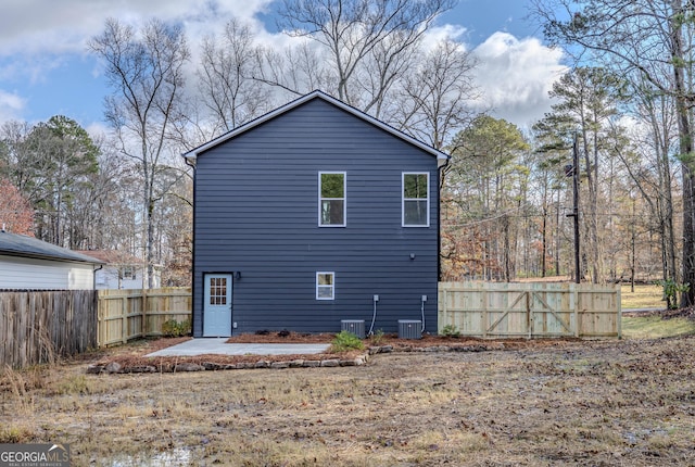 rear view of house featuring central AC