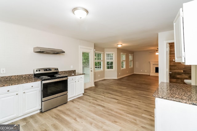 kitchen featuring white cabinets, light wood-type flooring, range hood, and electric stove