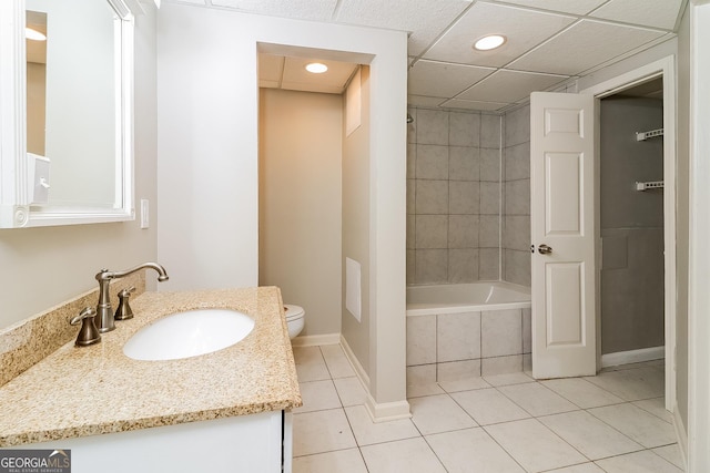 full bathroom with tile patterned floors, vanity, tiled shower / bath combo, and toilet