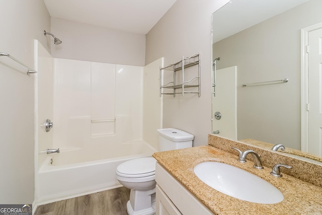 full bathroom with hardwood / wood-style floors, vanity, shower / bathtub combination, and toilet