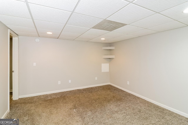 basement with carpet and a drop ceiling