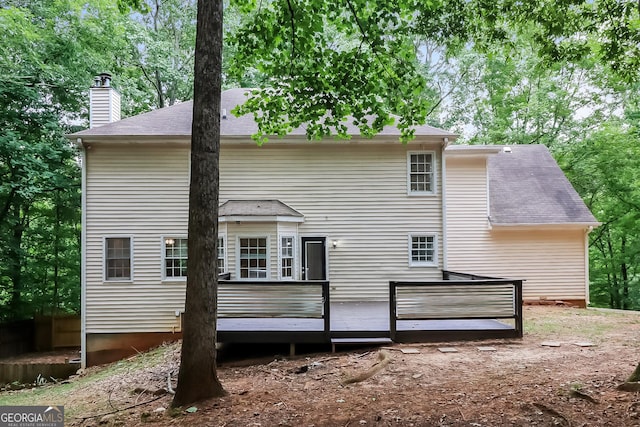 rear view of house with a wooden deck