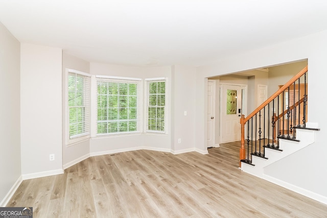 unfurnished room with light wood-type flooring