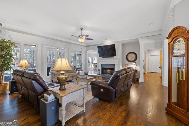 kitchen with crown molding, dark wood-type flooring, built in desk, a textured ceiling, and dark stone counters