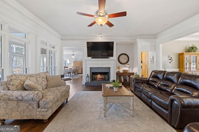 dining space with ornamental molding, dark wood-style flooring, baseboards, and a ceiling fan