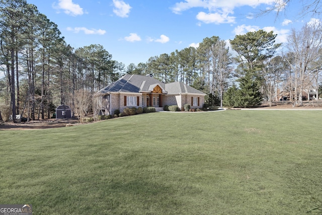 view of side of home featuring an outdoor structure, brick siding, a lawn, and a storage shed