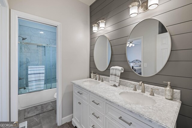 bathroom with vanity, wooden walls, and a tub