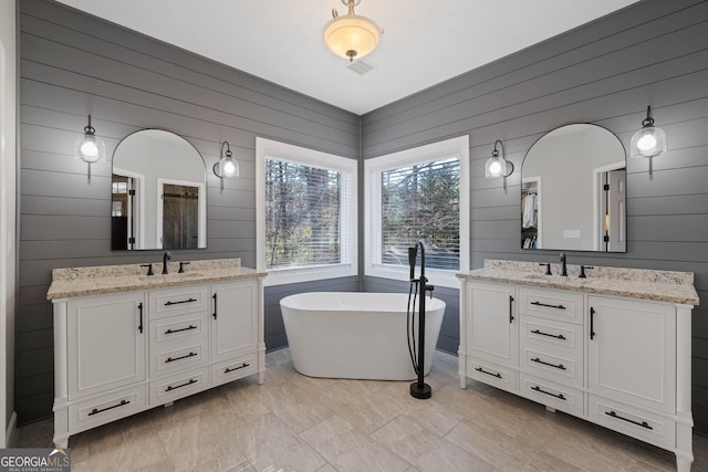 bedroom featuring baseboards, dark wood finished floors, a ceiling fan, a tray ceiling, and crown molding