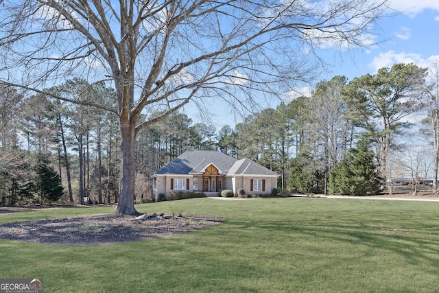 view of front of home with brick siding and a front yard