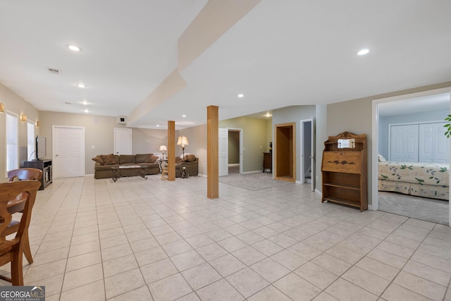 living room with a warm lit fireplace, ornamental molding, dark wood finished floors, and a ceiling fan