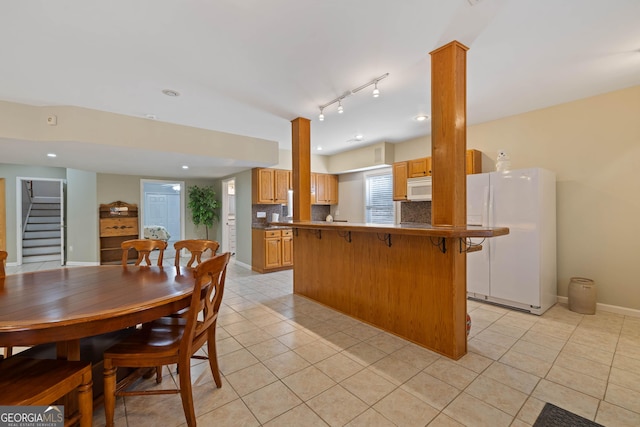 dining area with recessed lighting, baseboards, and light tile patterned floors