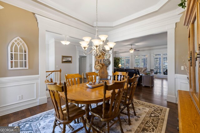 dining area featuring a decorative wall, a ceiling fan, ornamental molding, wainscoting, and dark wood-style floors