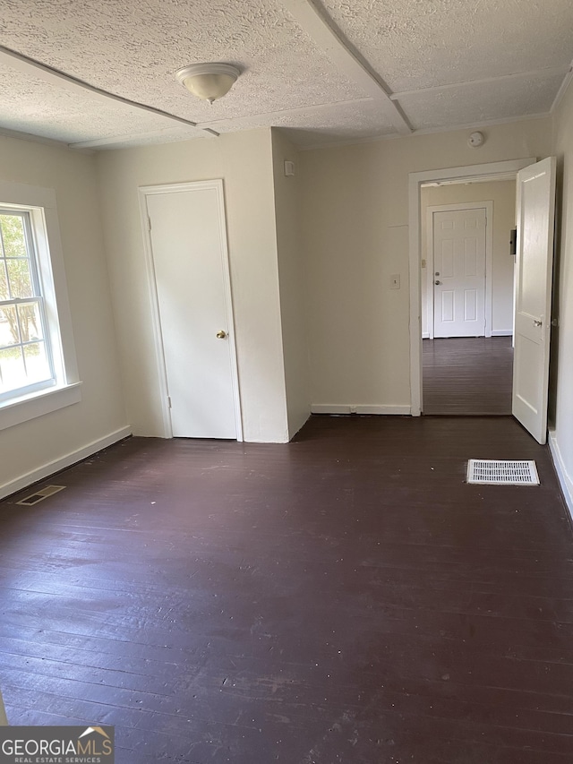 spare room with dark wood-type flooring