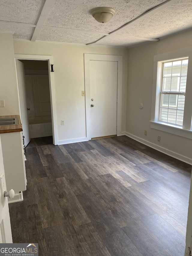 unfurnished bedroom with dark hardwood / wood-style floors