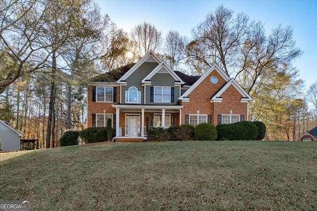 view of front facade featuring covered porch and a front yard