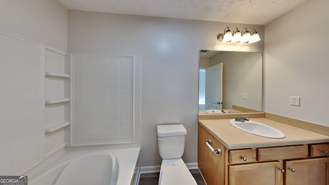 bathroom featuring vanity, toilet, and a textured ceiling