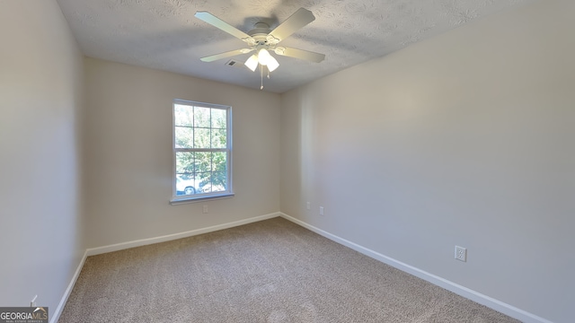 carpeted empty room featuring a textured ceiling and ceiling fan