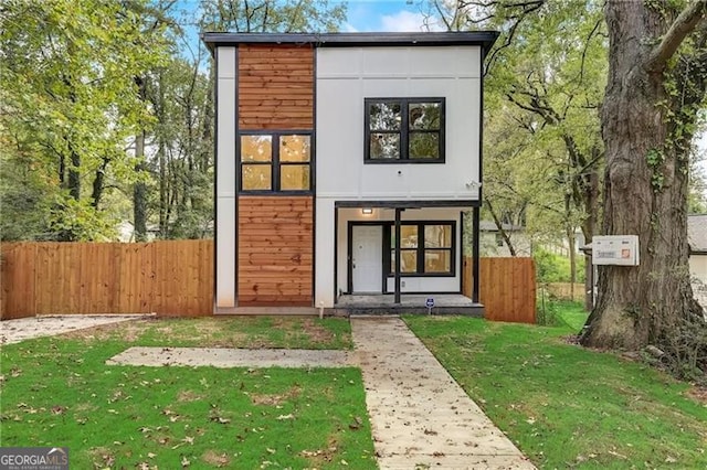 rear view of property featuring a lawn