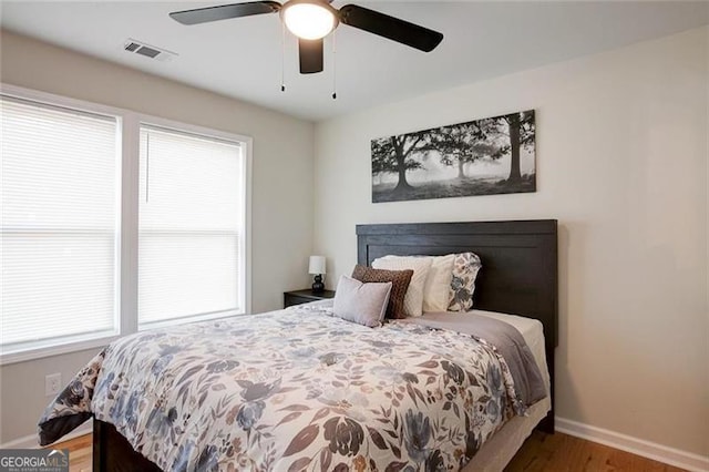 bedroom with hardwood / wood-style floors and ceiling fan