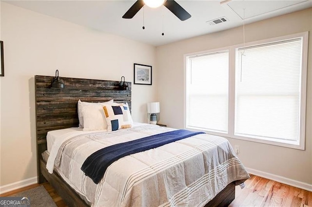 bedroom with hardwood / wood-style flooring and ceiling fan