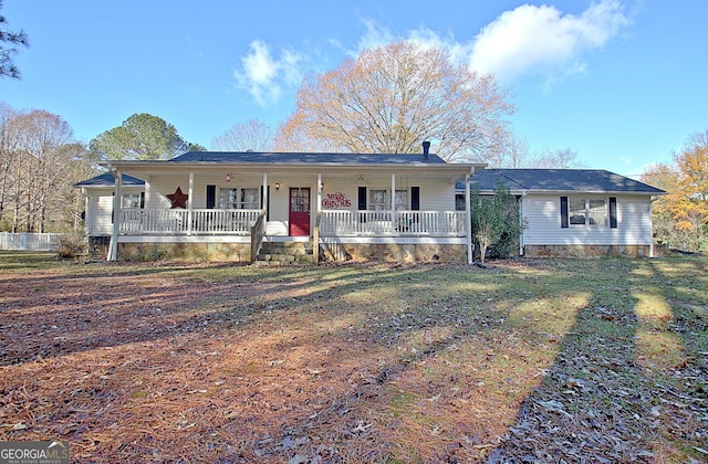 ranch-style house with covered porch and a front lawn