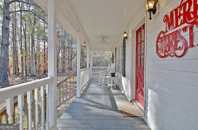 wooden terrace featuring ceiling fan and covered porch