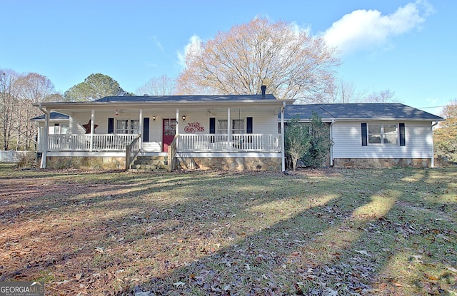 ranch-style house with a front yard and covered porch