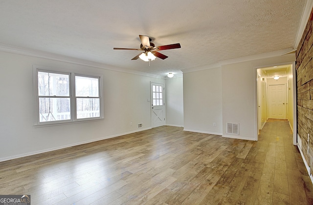 unfurnished room with ornamental molding, ceiling fan, a textured ceiling, and light hardwood / wood-style flooring