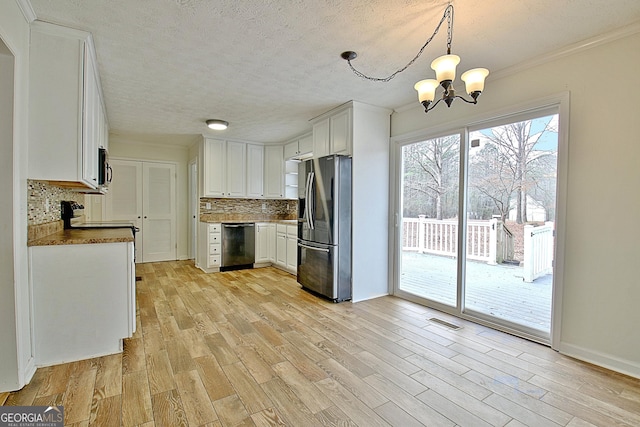 kitchen with light hardwood / wood-style flooring, hanging light fixtures, stainless steel appliances, white cabinets, and decorative backsplash