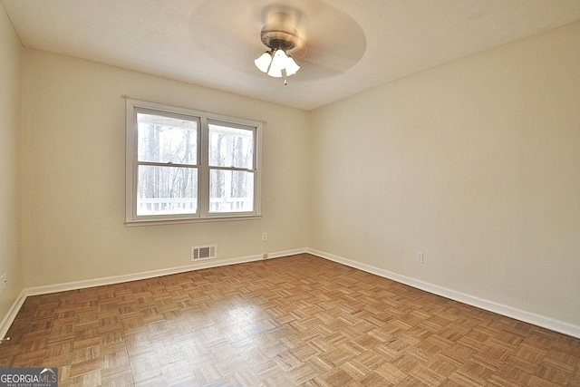 spare room featuring ceiling fan and light parquet flooring