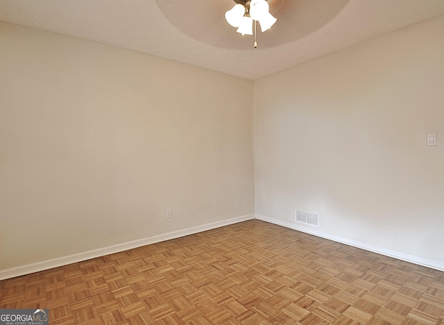 spare room featuring ceiling fan and light parquet flooring