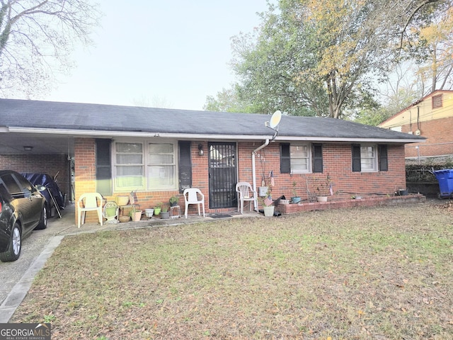 ranch-style home with a front lawn and a carport