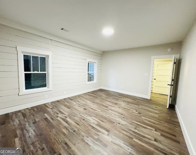 empty room with hardwood / wood-style floors