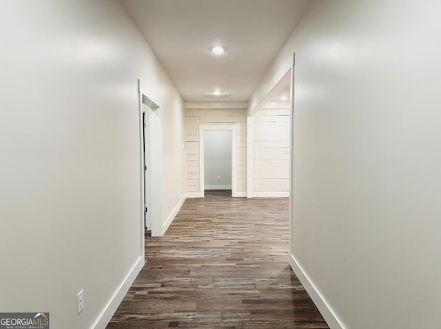 corridor featuring dark hardwood / wood-style flooring