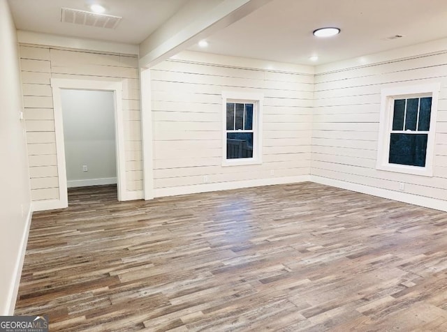 unfurnished room with hardwood / wood-style flooring