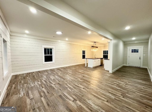 unfurnished living room with dark wood-type flooring